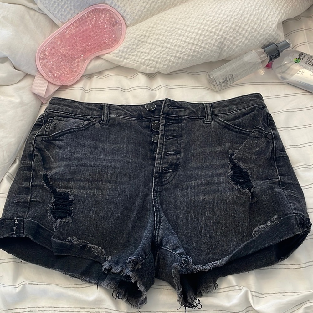 Acid wash black shorts with rips.